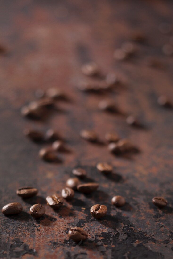 Espresso beans on a rusty surface
