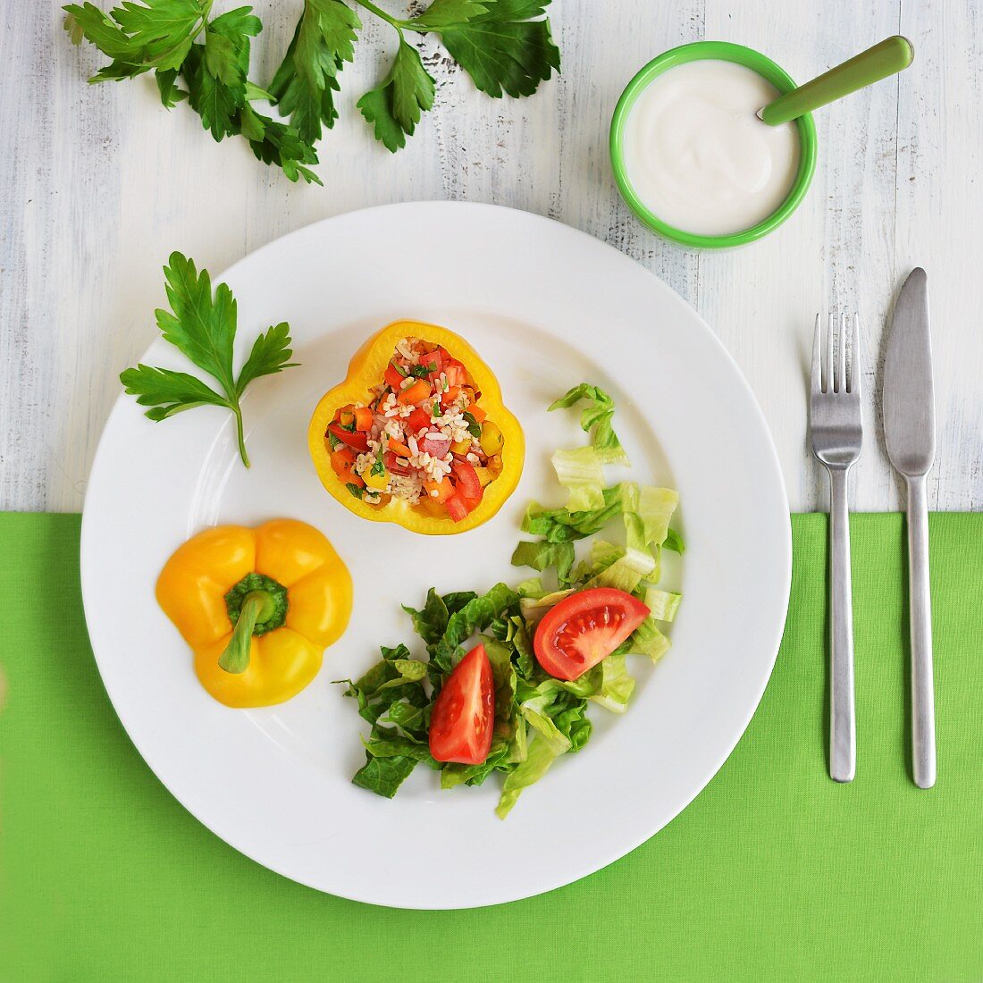 Yellow peppers filled with a rice, pepper and tomato salad