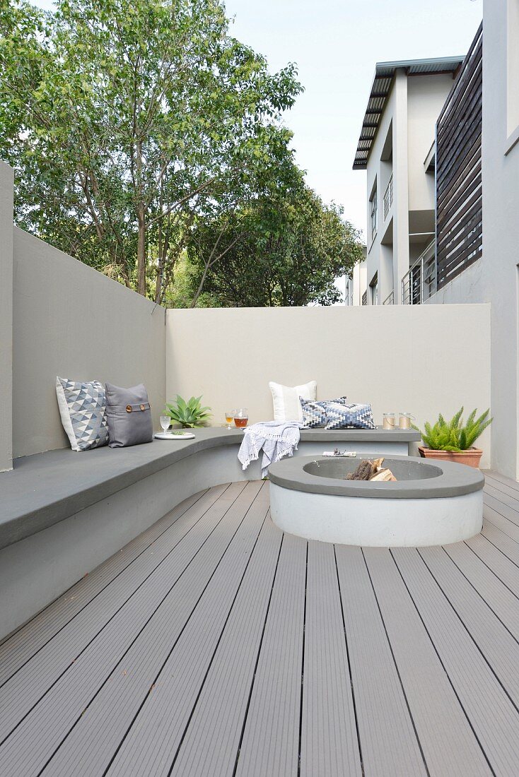 Masonry bench and hearth in modern courtyard