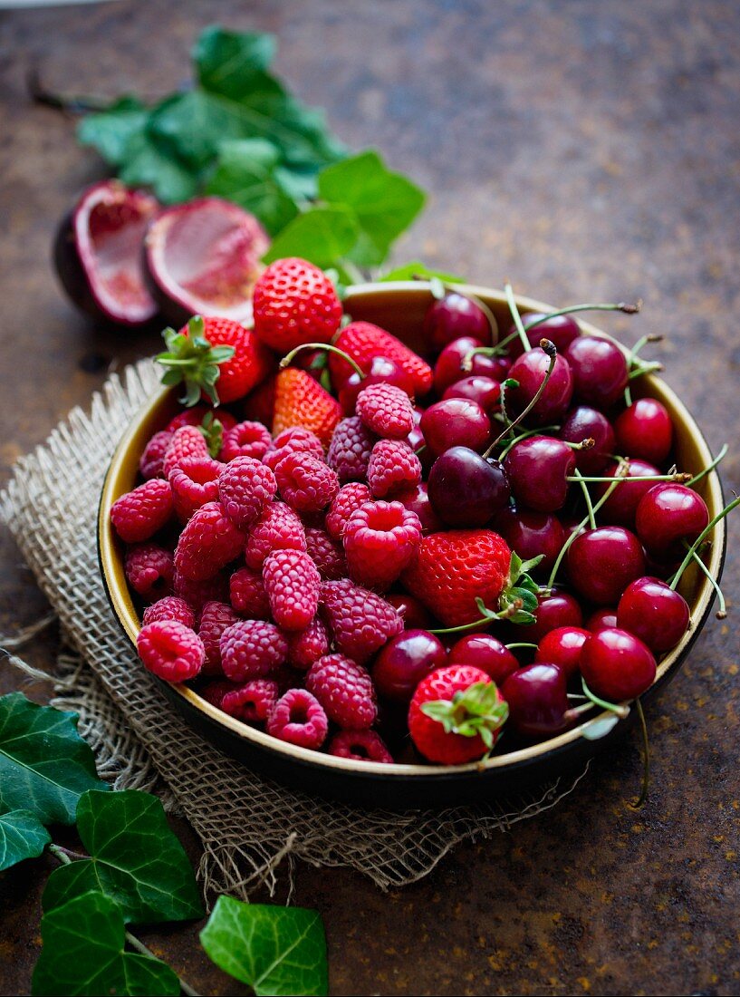 Fresh cherries, strawberries and raspberries in a bowl