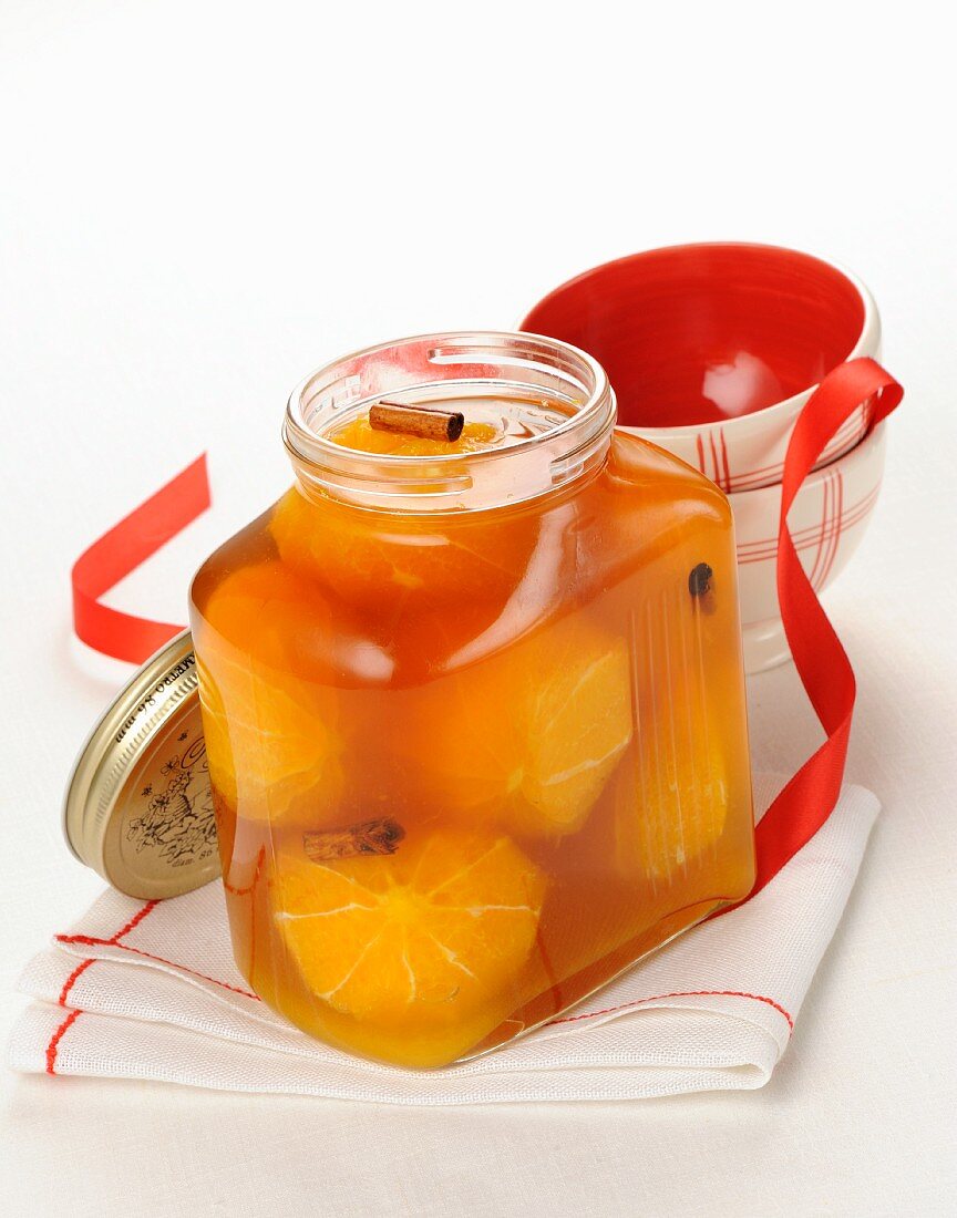 Brandy oranges with spices in a jar