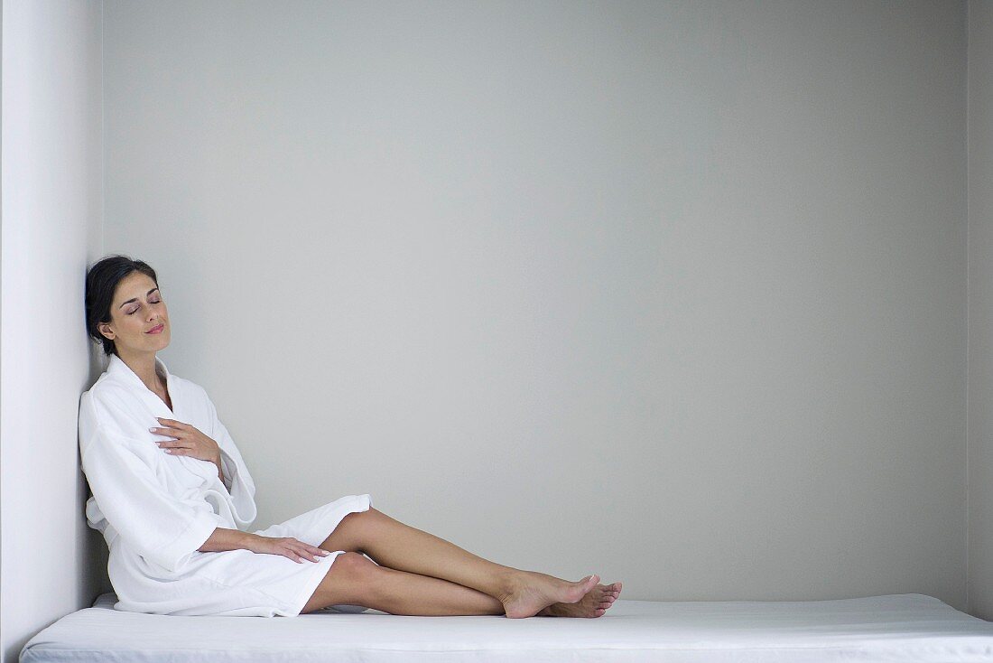 A brunette woman wearing relaxing in a spa