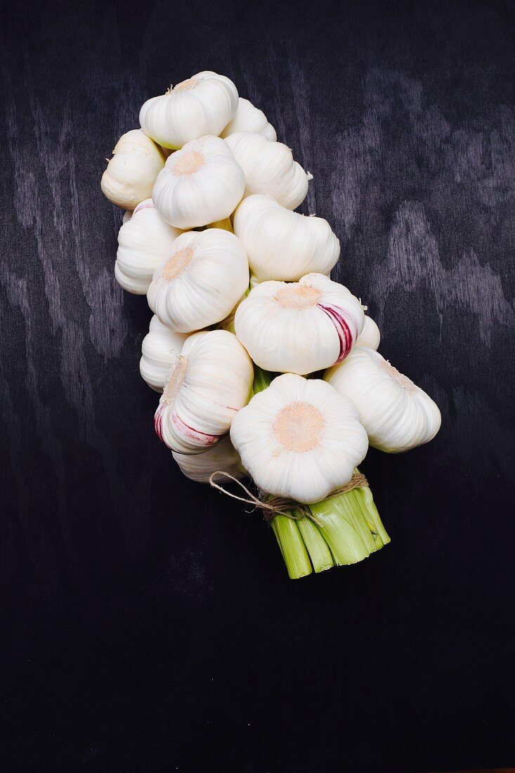 A string of garlic on the black surface