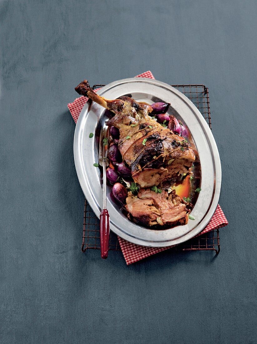 Oven-roasted shoulder of lamb with onions and herbs