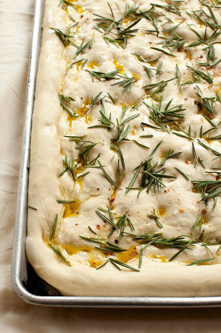 Close up of focaccia dough with herbs