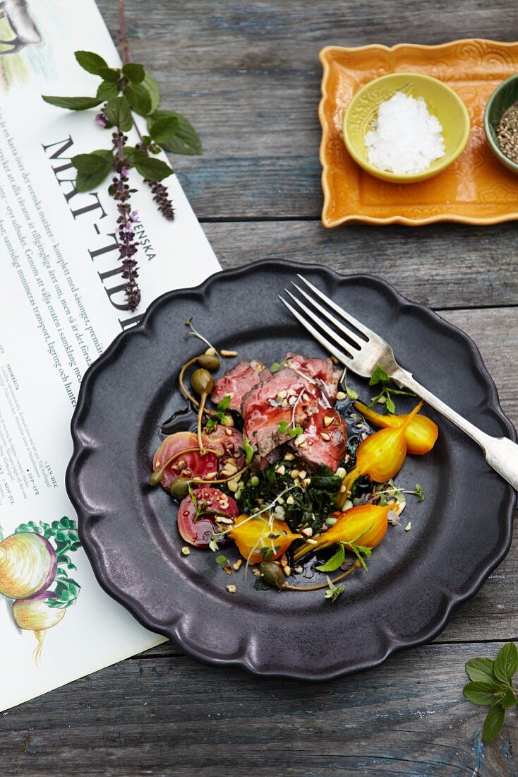 Beef with red and yellow beetroot, capers and herbs