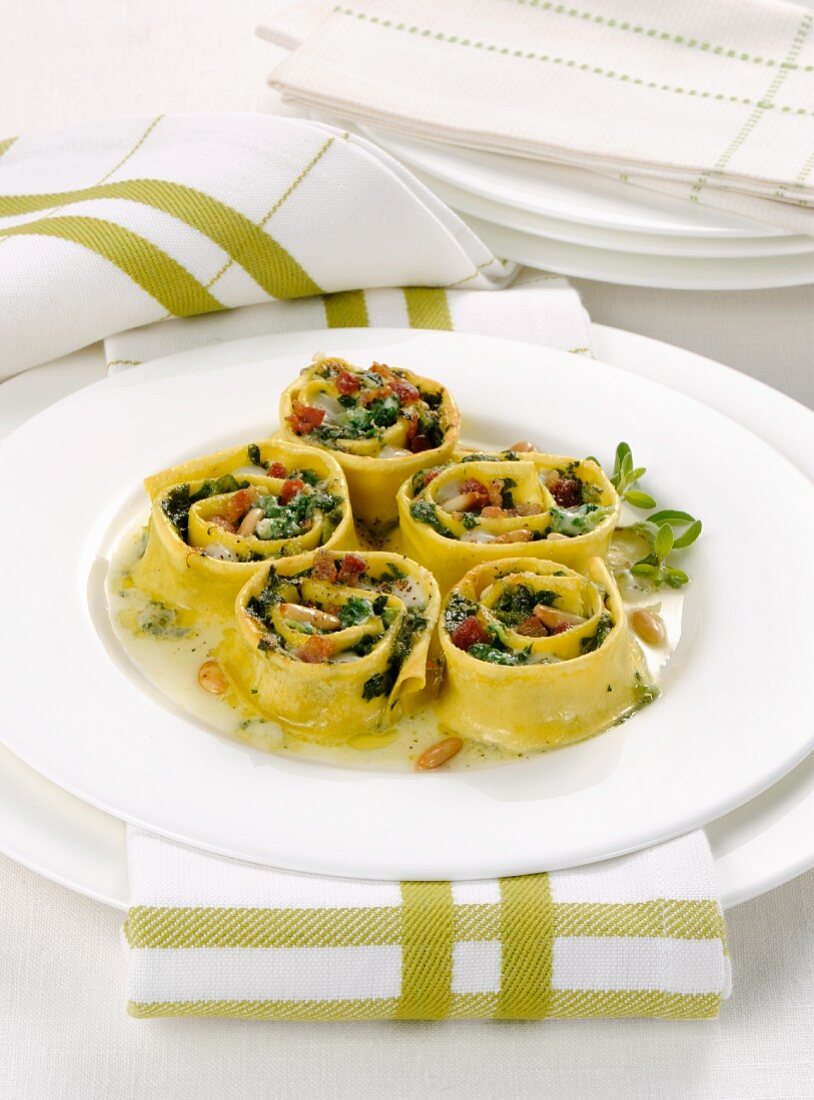 Gratinated pasta rolls with fresh herbs and pine nuts