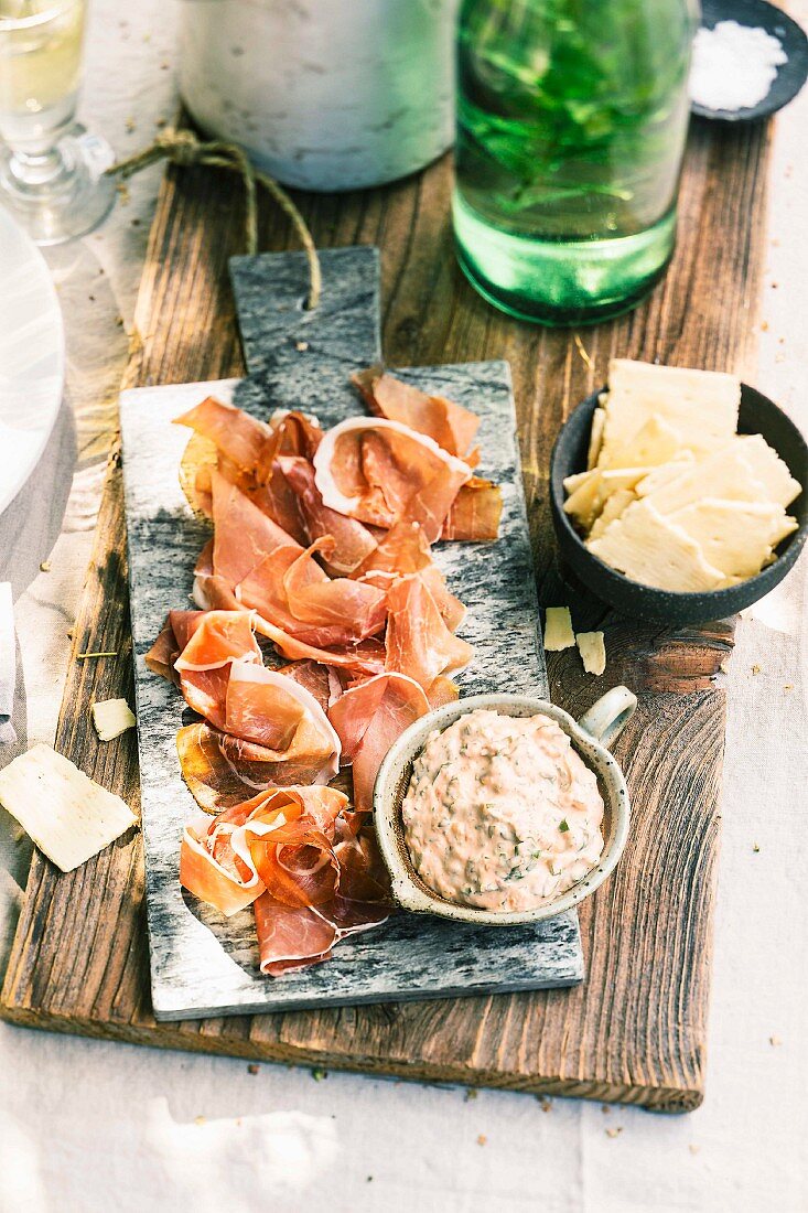 Ham antipasti with a pesto and cream cheese dip and crackers