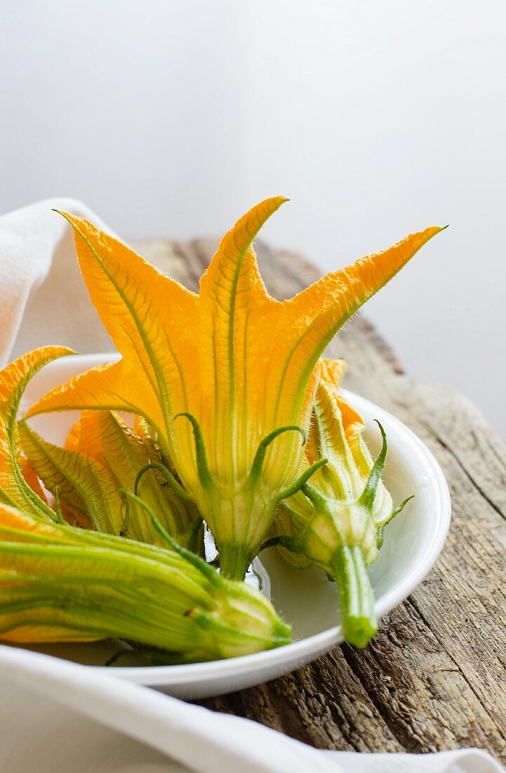 Courgette flowers in a ceramic bowl