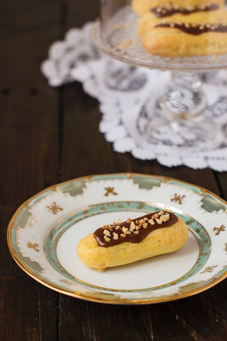 Chocolate eclairs with chopped nuts