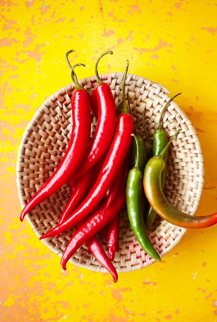 Fresh chilli peppers in a basket (seen from above)