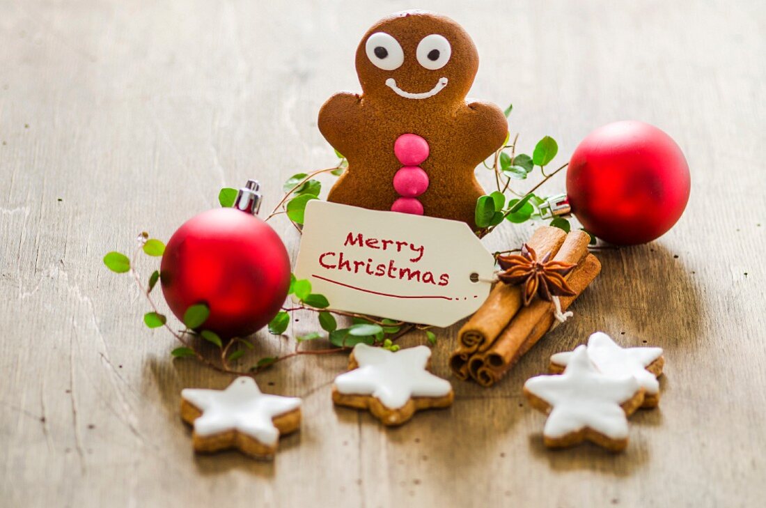 Christmas decorations with a gingerbread man, cinnamon stars and Christmas baubles