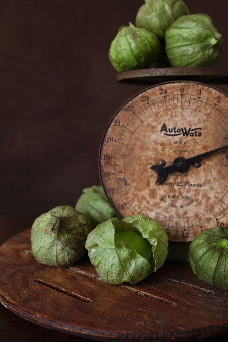 Fresh tomatillos on a pair of old kitchen scales