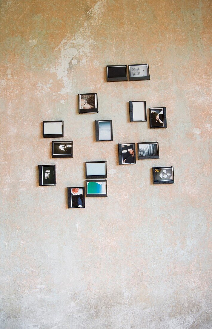 Photos in upcycled plastic boxes hung on wall