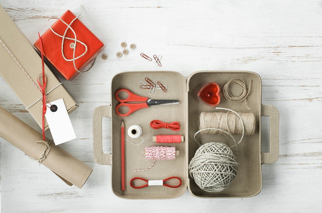 Craft supplies in a small cardboard suitcase