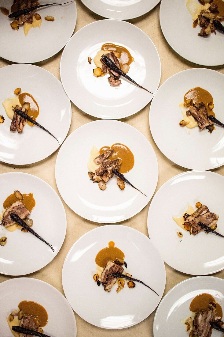 Artfully composed main-course plates for a pop-up fundraiser dinner with seasonal produce