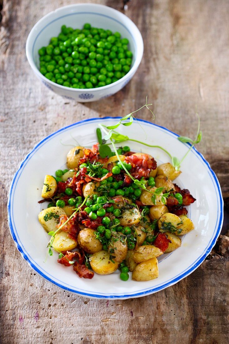 Baked potatoes with bacon and peas