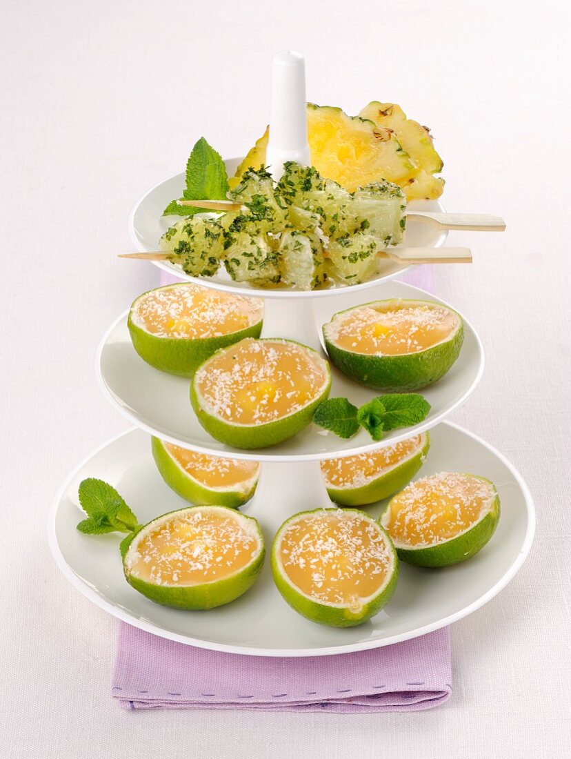 Lime cream served in lime skins with pineapple skewers