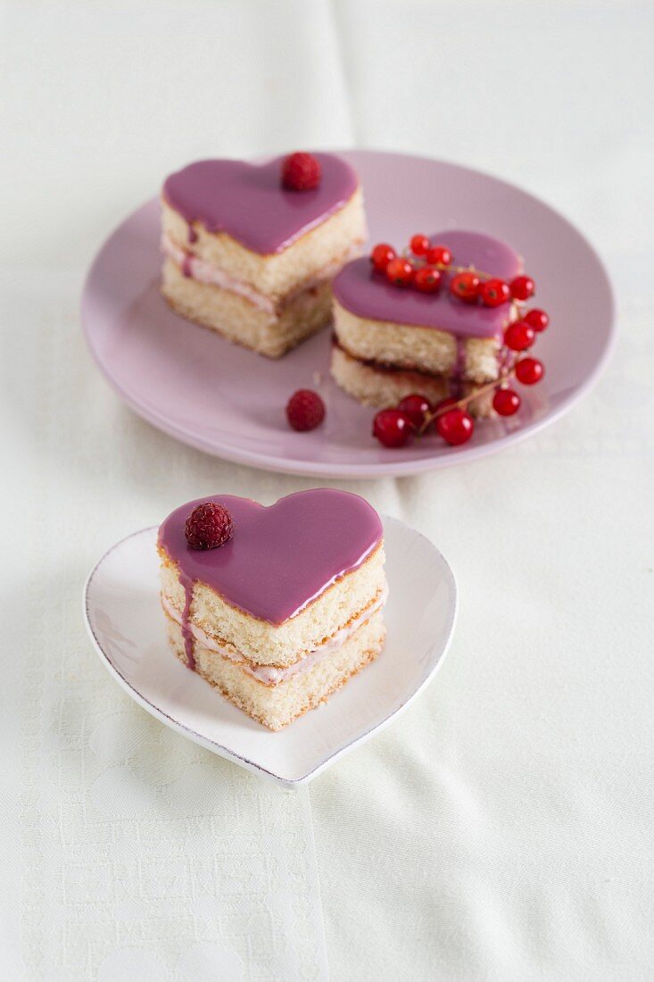 Heart-shaped sponge cakes with raspberry cream and redcurrant jelly