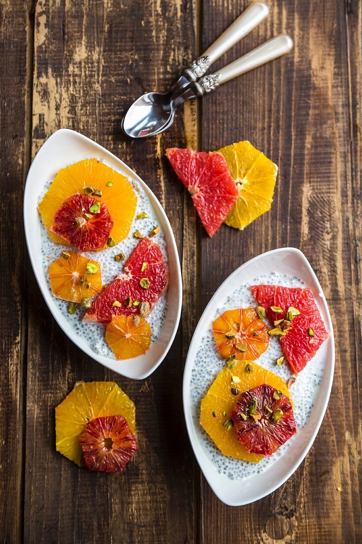 Chia pudding with slices of orange and grapefruit in bowls