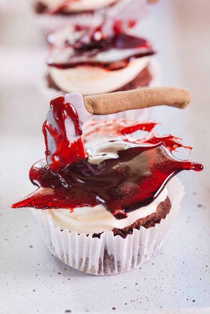 Halloween cupcakes decorated with axes in jelly 'blood'
