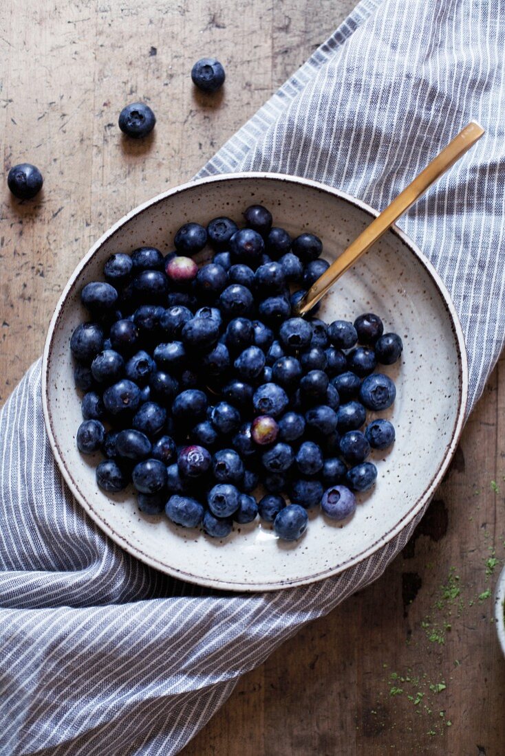 Fresh blueberries in a ceramic bowl (seen from above)