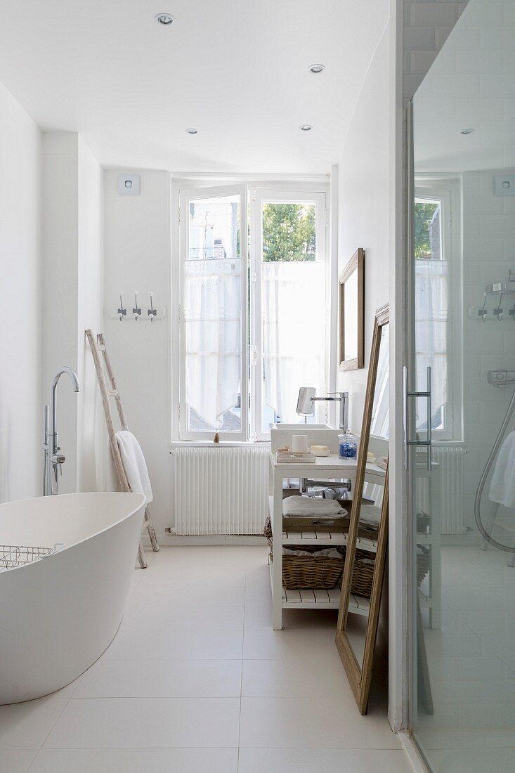 White, free-standing bathtub in bathroom