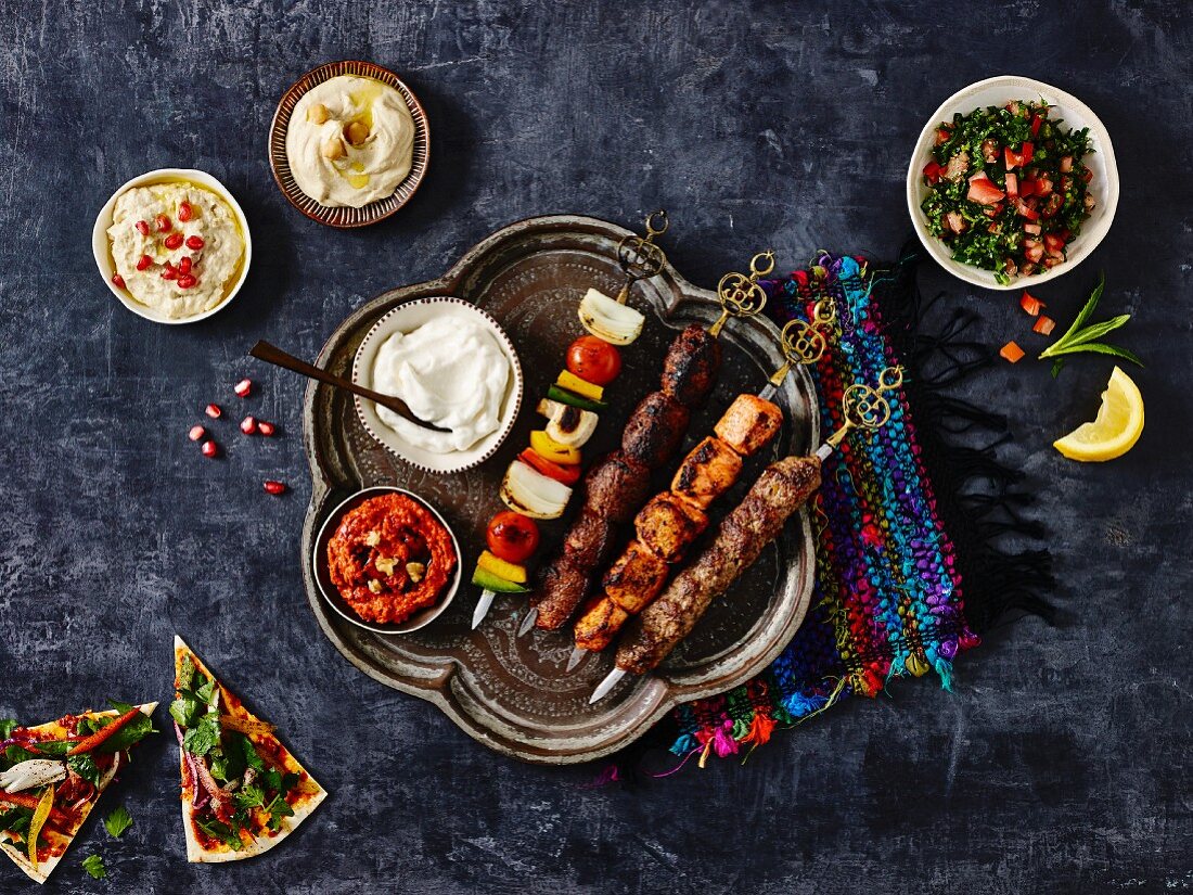 Middle Eastern kebab platter with dips, tabbouleh and unleavened bread