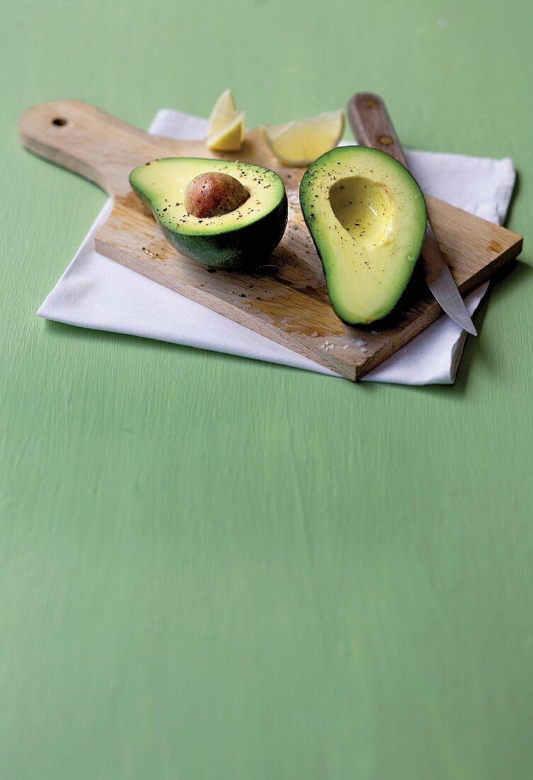 Sliced avocado on a wooden board