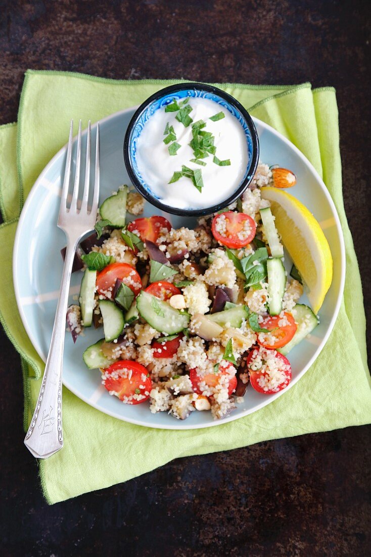 Couscous salad with aubergine, cherry tomatoes, cucumber and herbs