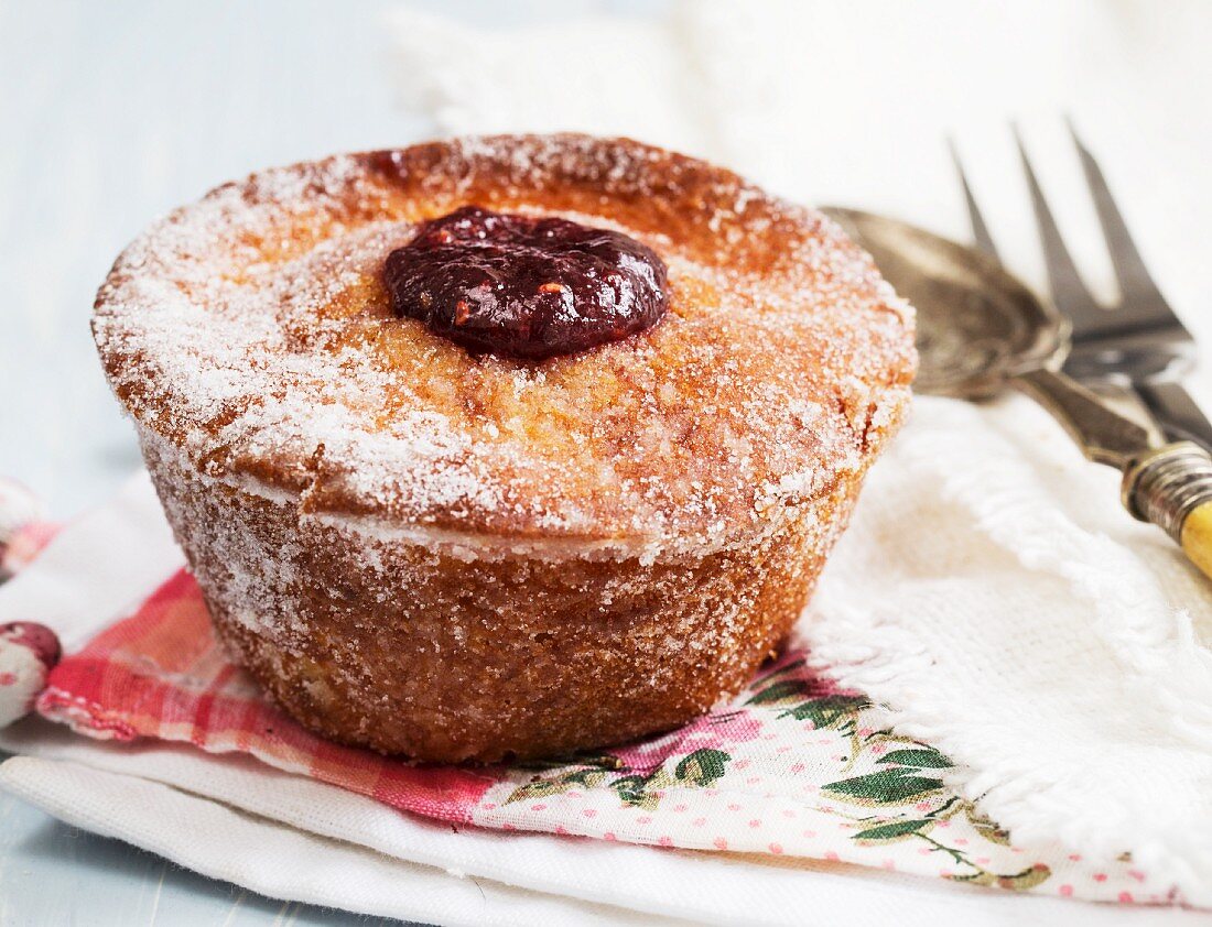A doughnut muffin with raspberry jam