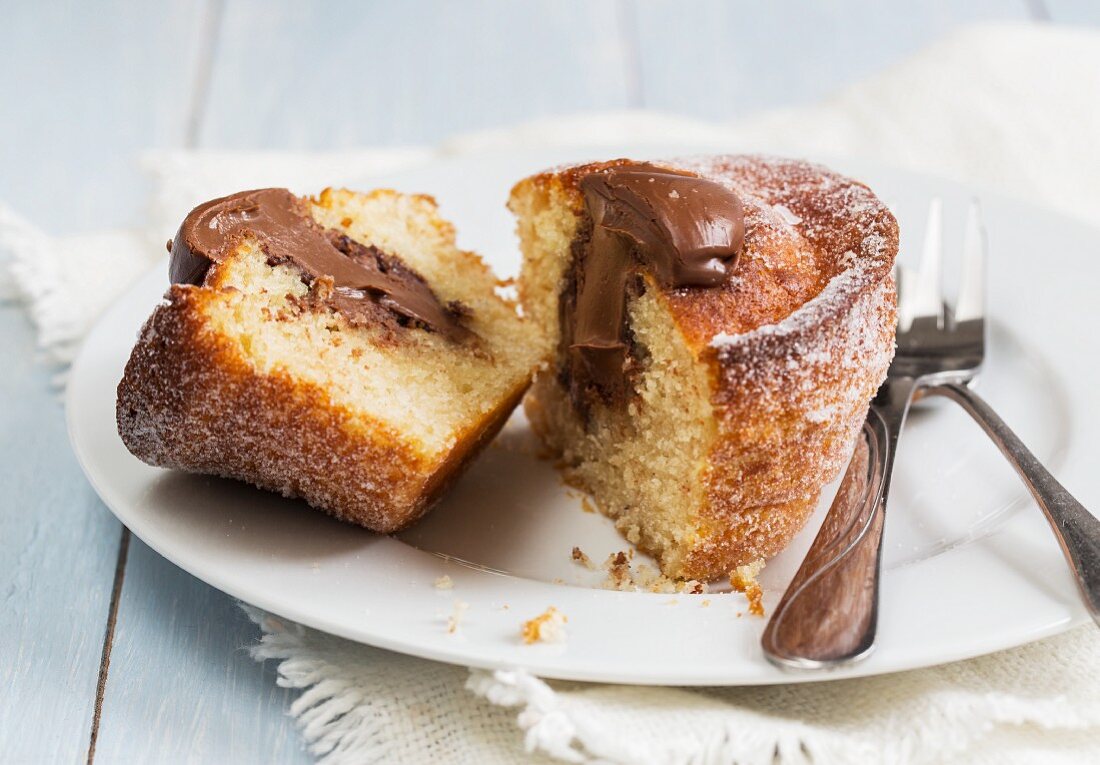 A doughnut muffin filled with chocolate cream, sliced