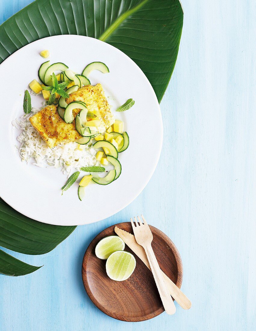 Curried fish on a bed of rice with a mango and cucumber salad