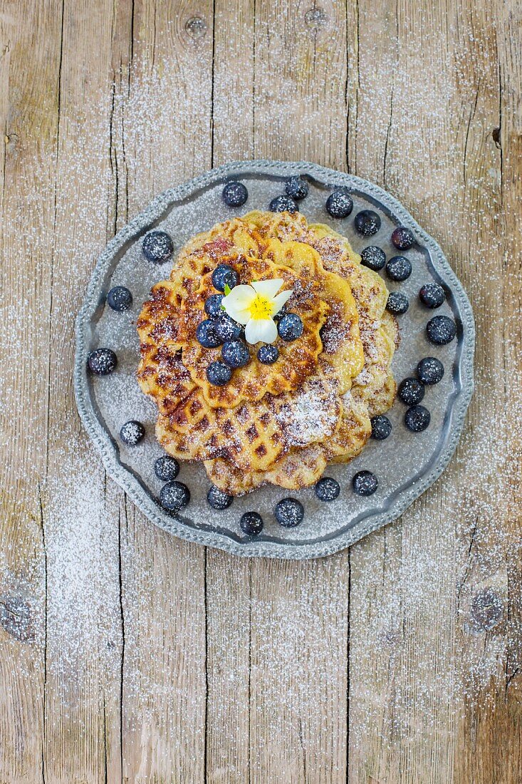 A stack of lemon buttermilk waffles with blueberries