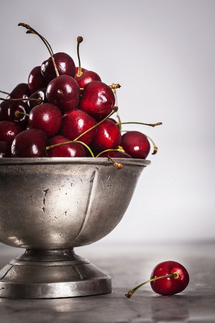 Fresh cherries in a metal bowl