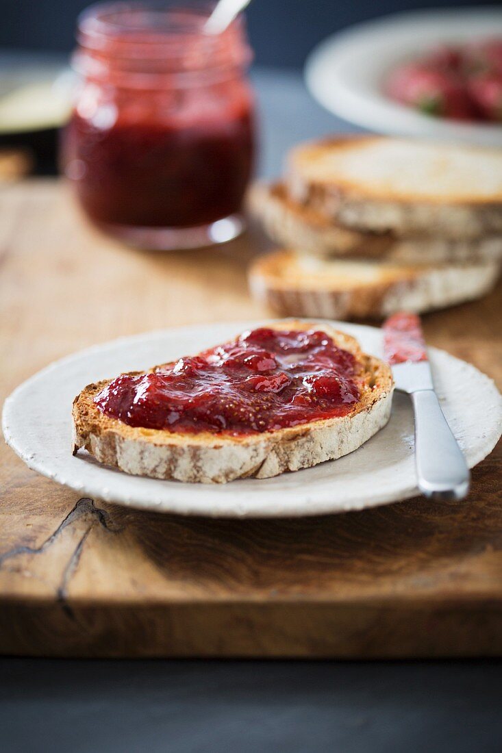 Strawberry jam on a slice of bread