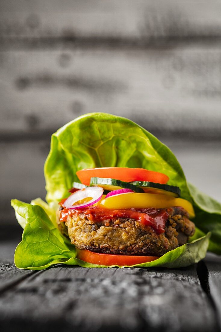 A gluten-free veggie burger in a lettuce leaf