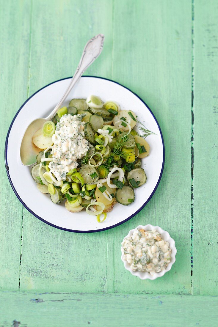 Potato salad with gherkins, leeks and a yogurt sauce made with herbs and hard-boiled egg