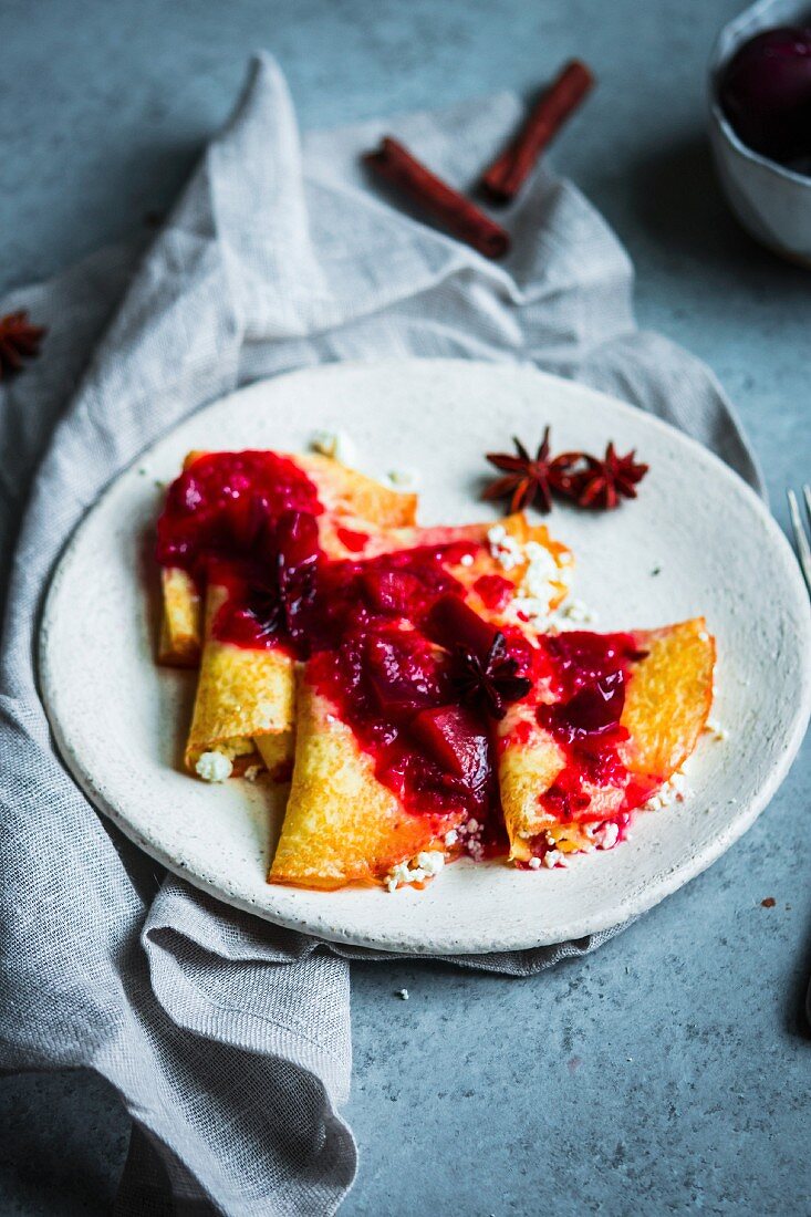 Russian crepes with cottage cheese and plum and star anise compote