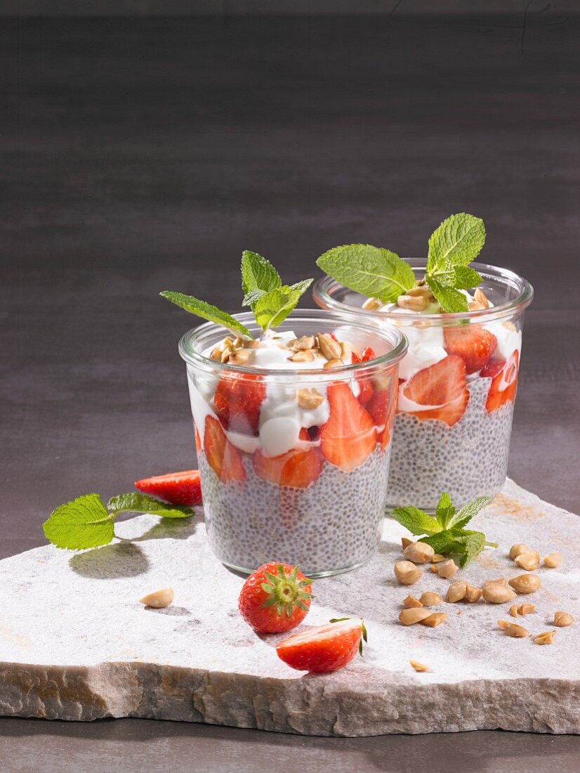 Chia seed puddings with strawberries, yoghurt, nuts and mint