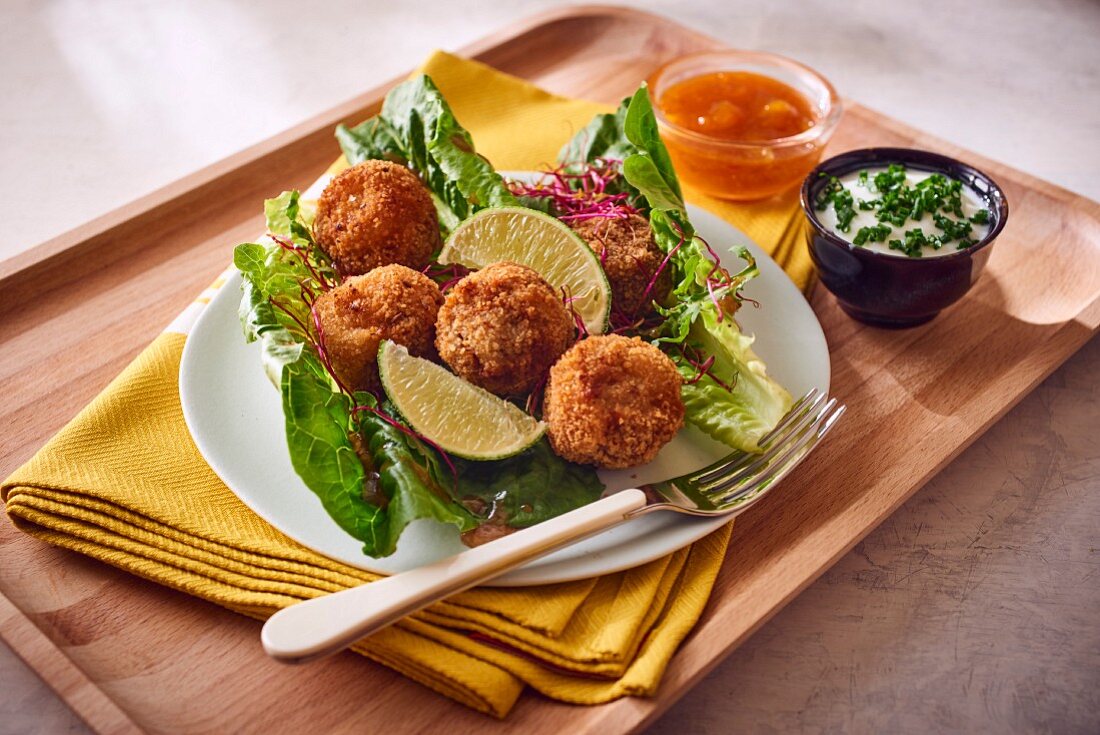 Falafel on lettuce leaves with mango chutney and a yoghurt dip