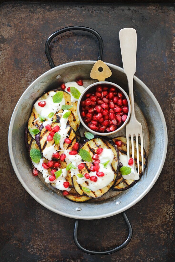 Grilled aubergines with yoghurt, pomegranate seeds and peppermint