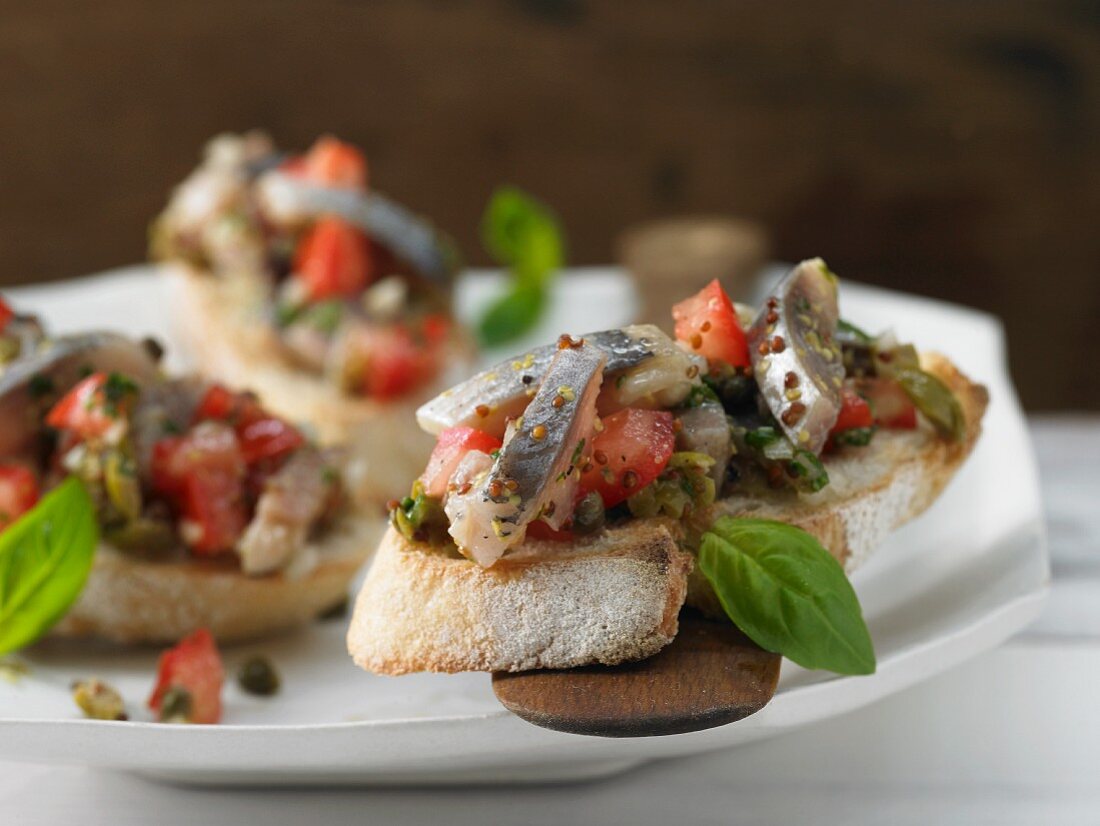 Soused herring and tomato salad on fresh baguette