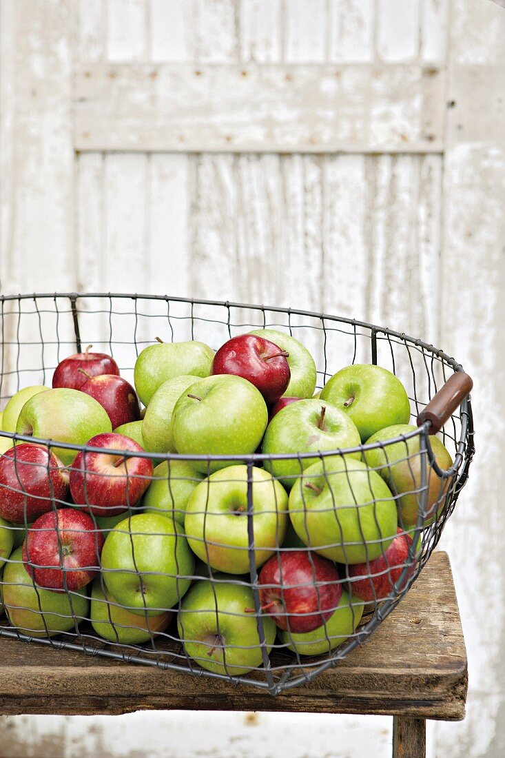 Fresh apples in a wire basket
