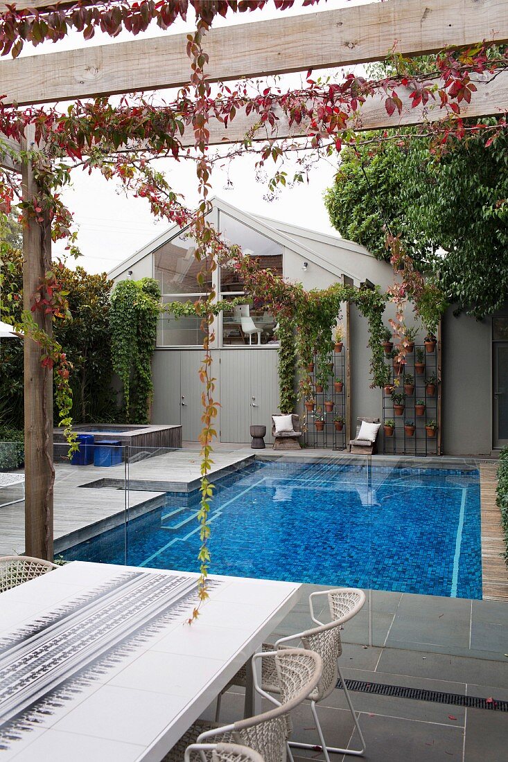 View from terrace with pergola on pool and gable facade