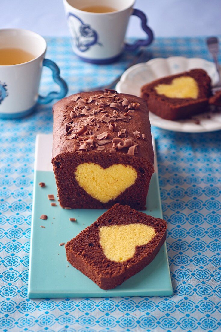 A sliced chocolate loaf cake with a heart made from plain cake mix