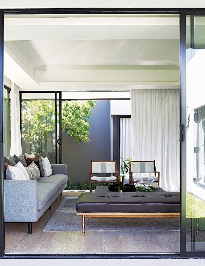 View into living room with glass walls