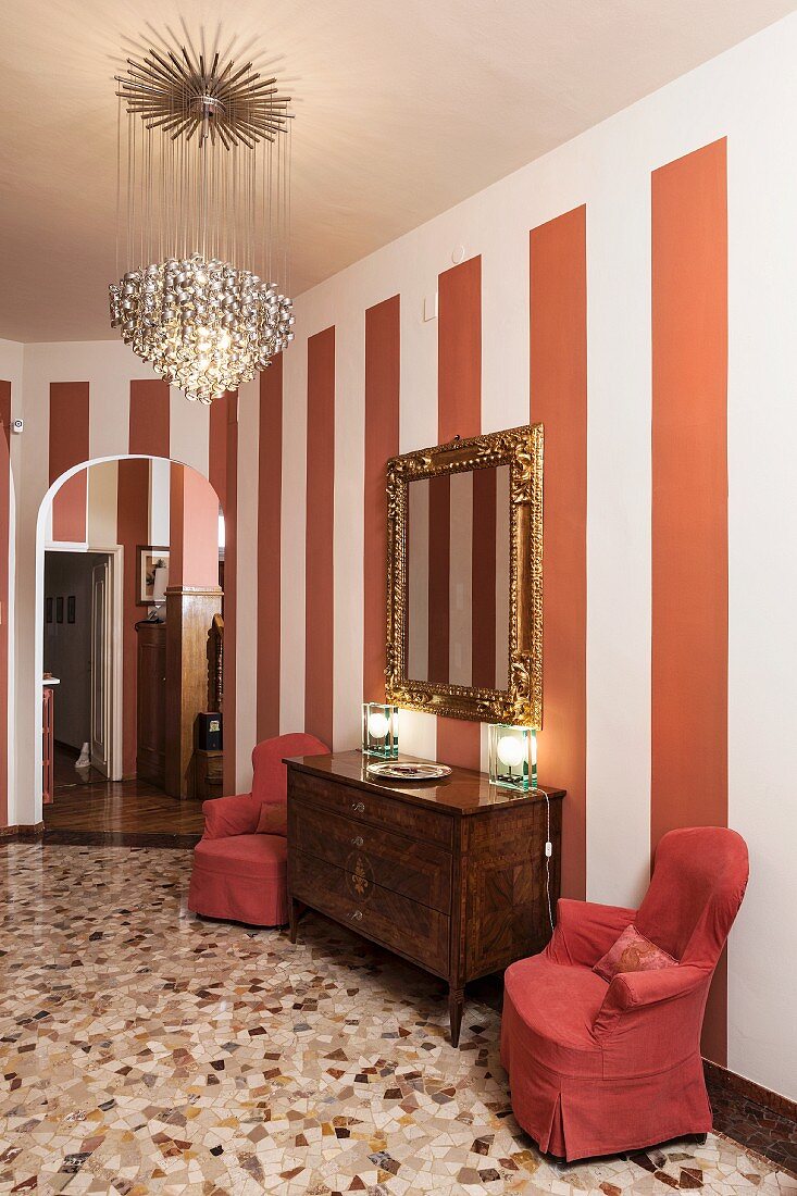 Terrazzo floor, striped wall and classic furniture in hallway