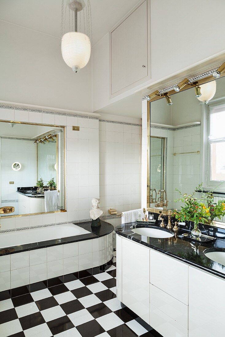 Mirrored walls and chequered floor in bathroom