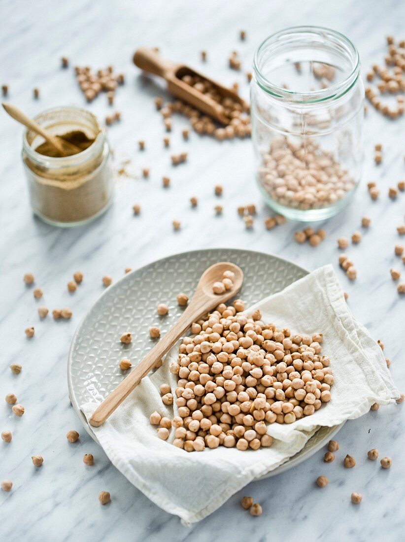 Chickpeas on a plate, in a jar and on a spoon